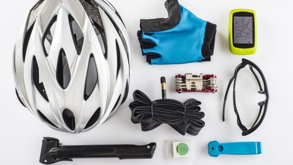 Cycling holiday packing items laid out on white background