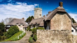 The best Isle of Wight resorts, towns and villages like this chocolate box village with thatched roofs and stone church