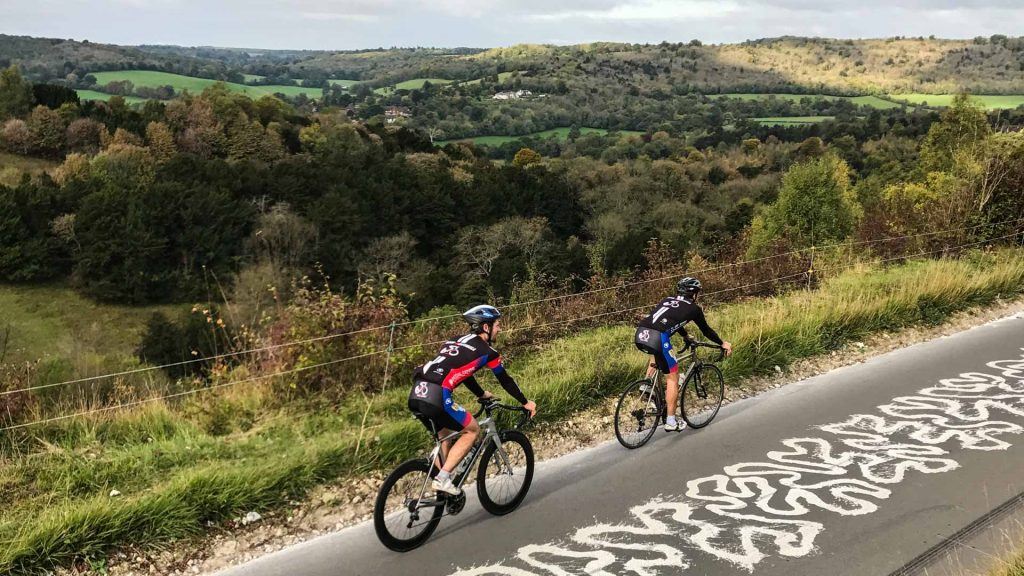 Two cyclists on Box Hill with views to left