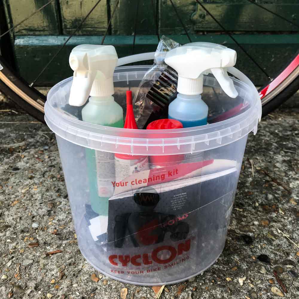 Cycling bike care cleaning kit in tub on ground