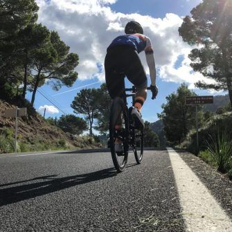 Cyclist cycling hilly coast road in Mallorca