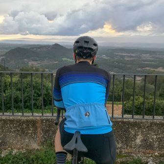 Cyclist admiring view over sunset over Mallorca