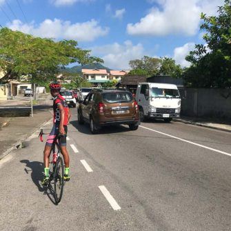 Cyclist in traffic near Victoria Seychelles