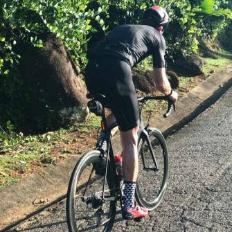 Cyclist cycling Mont Plasir Road Seychelles