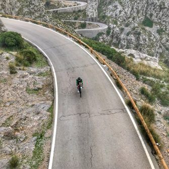 View down onto cyclist from bridge on Mallorca Sa Caobra road