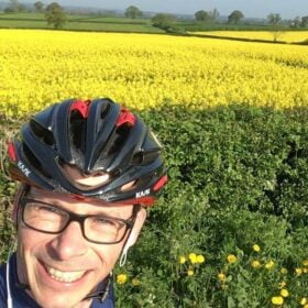 Monty from Sportive Cyclist in front of oilseed rape field in Derbyshire