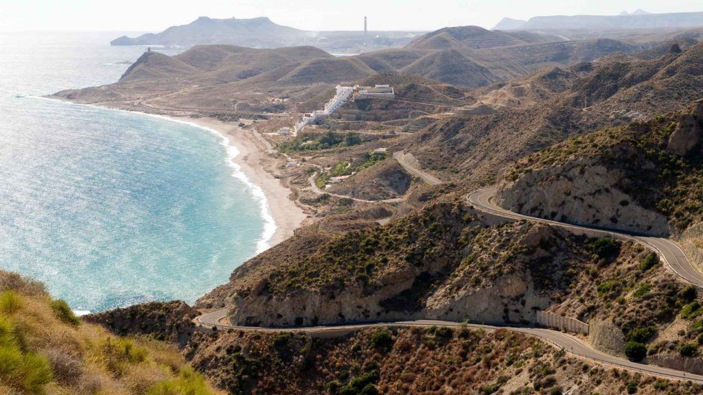 Cycling Andalucia's coastline with road and coast stretching into distance