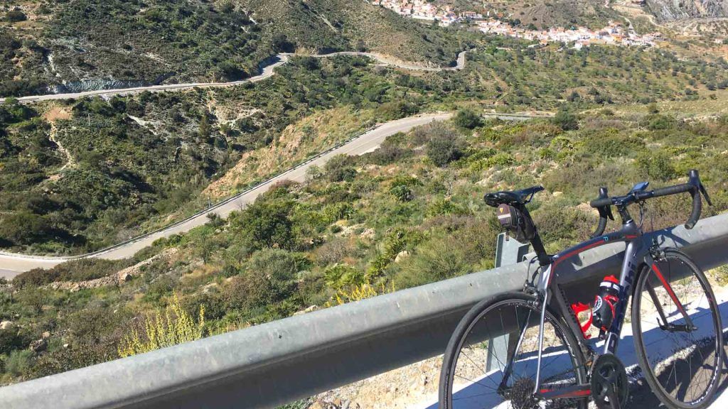 Cycling Andalucia with road stretching into distance and bike in foreground