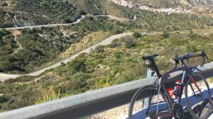 Cycling Andalucia with road stretching into distance and bike in foreground