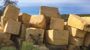 Bike photographed against huge stone blocks in the Valley of the Blocks, Almeria