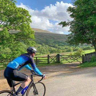 Cyclist cycling through Coverdale, Yorkshire Dales