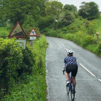 Cyclist cycling up Greenhow Hill, Pateley bridge, yorkshire dales