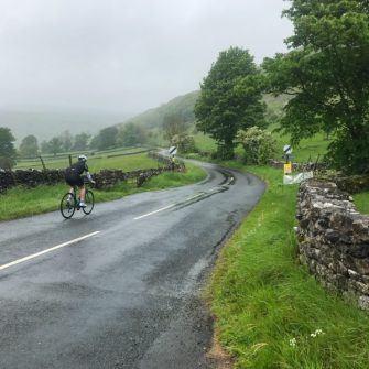 Cyclist at the bottom of the Kidstones Pass, Yorkshire Dales