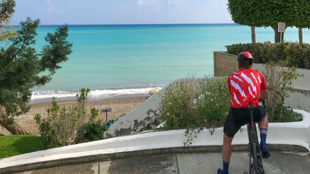 Cycling to Pissouri Bay, Cyprus, road cyclist looking out to sea