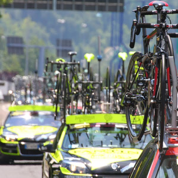 Bikes on the roofs of tour de france cycling team cars