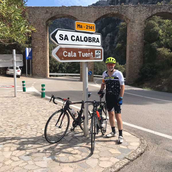 Road cyclist at the turning for Sa Calobra cycling route