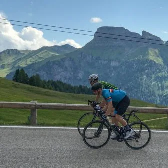 Two cyclists on the Passo Pordoi, Italian Dolomites