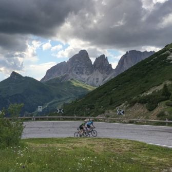 Cyclists cycling the Passo Pordoi cycling climb in the Dolomites, Italy