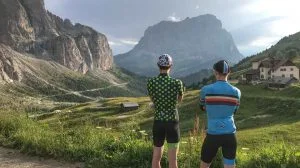 Two road cyclists looking at the view whilst cycling in the Dolomites, Italy