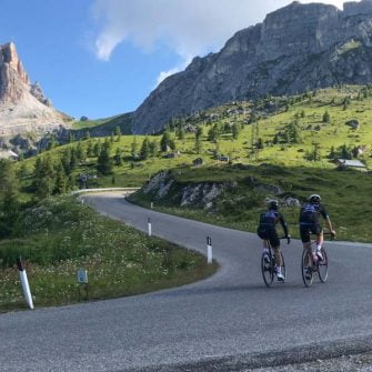 Two cyclists on Passo Giau, Dolomites nearing the summit