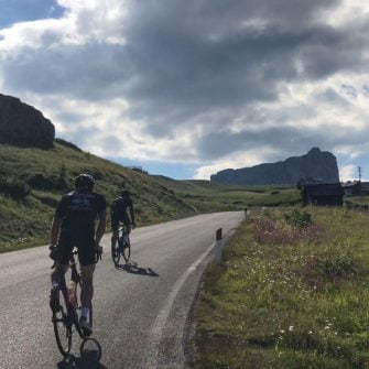 Two cyclists nearing the summit of the Passo Giau cycling climb, Dolomites