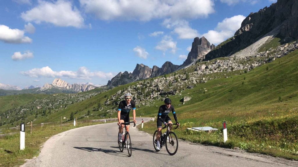 Two cyclists cycling up Passo Giau, Dolomites, Italy