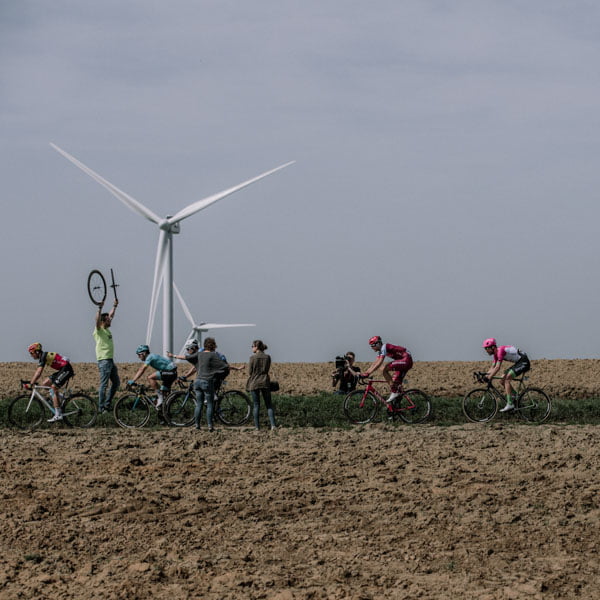 Cyclists cycling through rural terrain