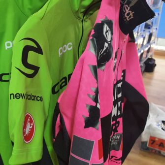 Pro team cycling jerseys in green and pink