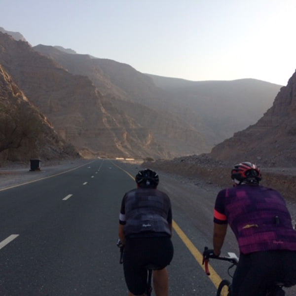 Cyclists cycling through Jebel Jais mountains, UAE