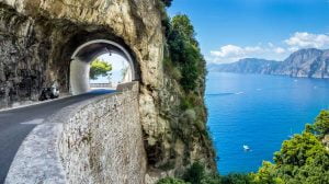 Tunnel above sea in Amalfi coast, an amazing place to go cycling in Italy