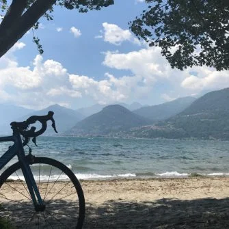 Cycling Lake Como with bike on beach at Lake Como