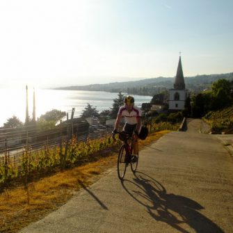 Cyclist cycling around Geneva and its lake