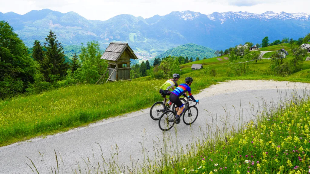 Two cyclists cycling in the Slovenian Alps