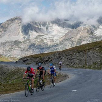 Four cyclists on a pass of the Route des Grandes Alpes in France