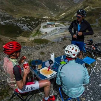 Cyclists eating lunch on the route des grandes alpes cycling tour