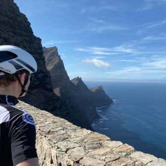 Cyclist looking down the coastline of Gran Canaria