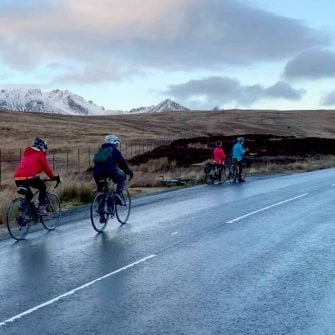 Cyclists in winter on The String, Arran, Scotland