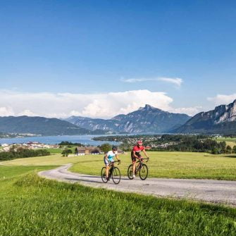 Cycling Austria with a lake behind and meadows