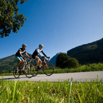 Two cyclsits cycling through Grossglockner region Austria (credit Pinzgau_Heiko Mandl)