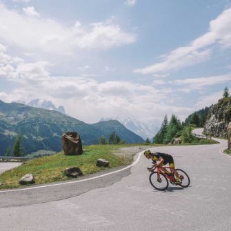 Cyclist descending a Swiss mountain pass