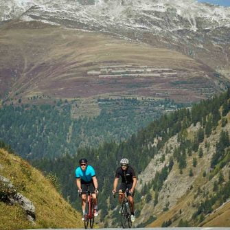 Two cyclists climb the Nufenen Pass, Switzerland