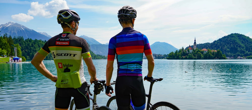 Two cyclists looking out over Lake Bled in Slovenia
