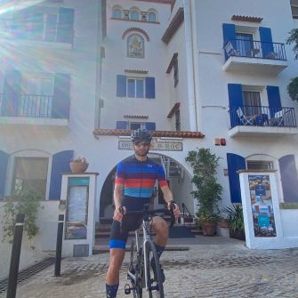 Hotel San Roc with cyclist in front
