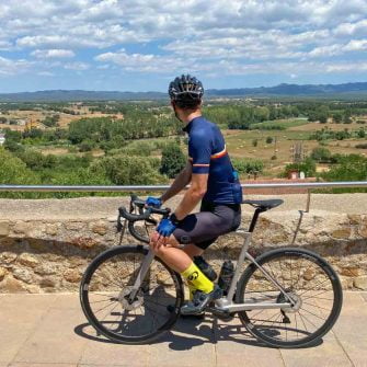 Cyclist admiring the view in Les Gavarres region of Costa Brava