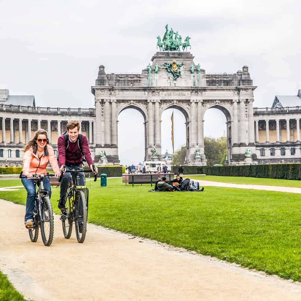 Two cyclists enjoy their cycling in brussels park