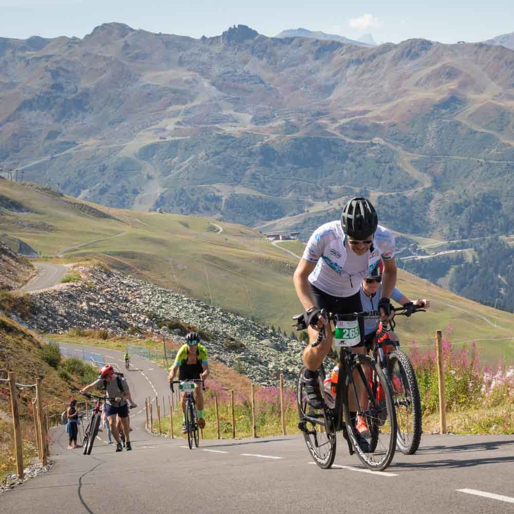 Cyclists riding their cycling in the alps steep mountain slopes