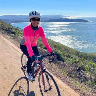 Cyclist with view from Hawk Hill 