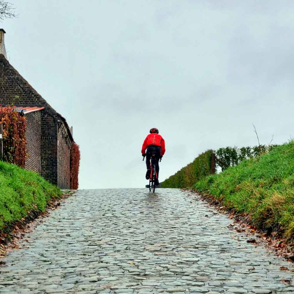 A cyclist on a winter morning in the village bike tours belgium