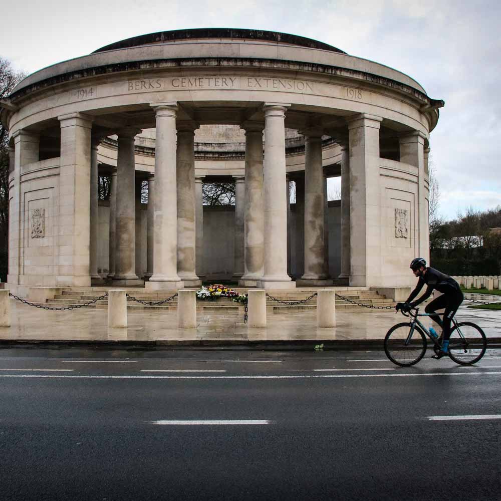 A cyclist on a city street on a rainy day come on belgium bike tour
