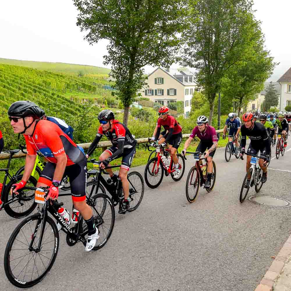 Cyclists are cycling on the hilly roads of the village schleck gran fondo